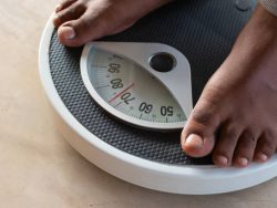 Male on the weight scale for check weight. Diet and weight control concept.